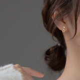 Silver Star Earrings in gold, modeling gold star earrings 